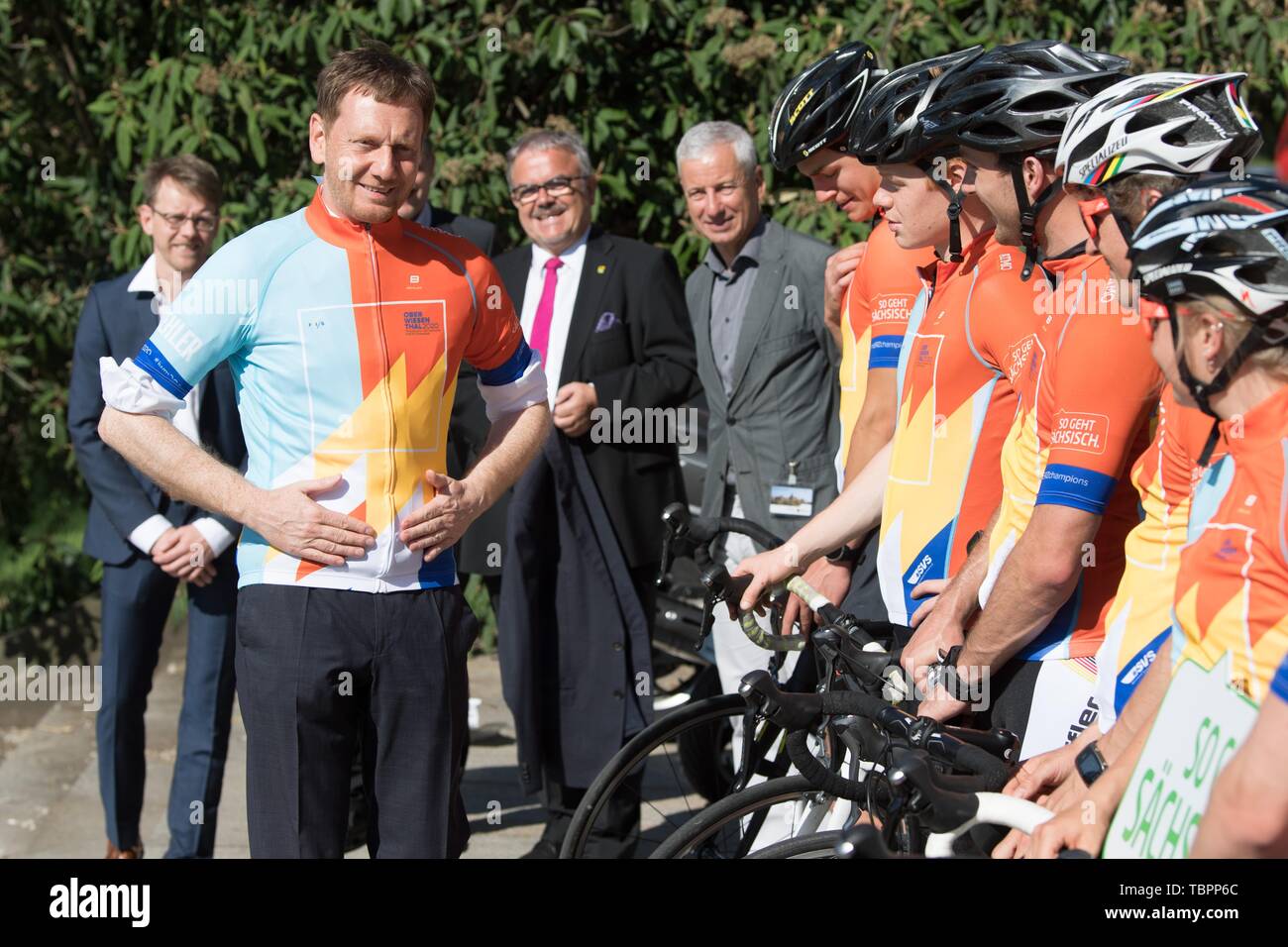 Dresden, Germany. 03rd June, 2019. Michael Kretschmer (CDU, l), Prime Minister of Saxony, wears a cycling jersey for the start of the summer cycle tour for the upcoming Nordic Junior World Championship 2020 in Oberwiesenthal, Saxony. On the same day, organisers and athletes from Dresden will start by bicycle in the direction of Oberwiesenthal to draw attention to this major event. Credit: Sebastian Kahnert/dpa-Zentralbild/ZB/dpa/Alamy Live News Stock Photo