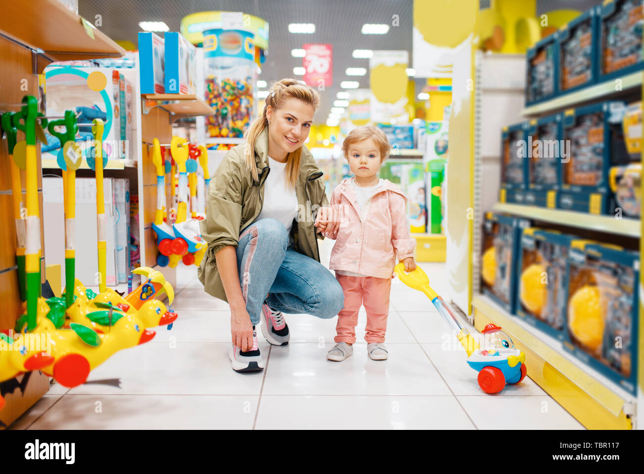 Mother with little daughter in kids store Stock Photo Alamy