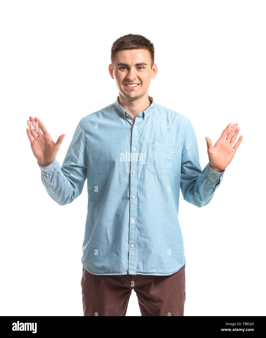 Young deaf mute man using sign language on white background Stock Photo
