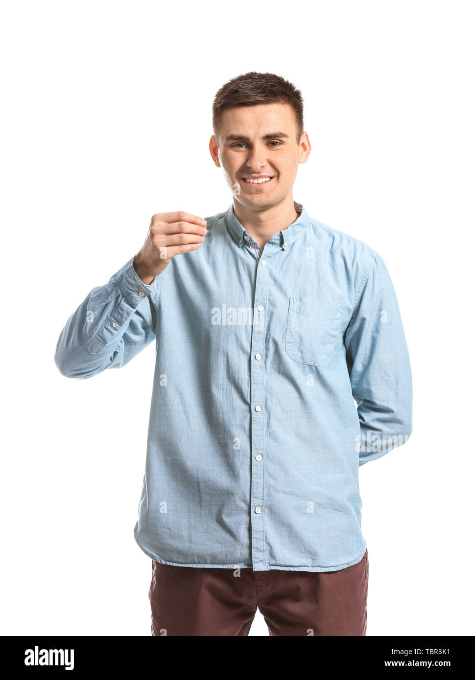 Young deaf mute man using sign language on white background Stock Photo