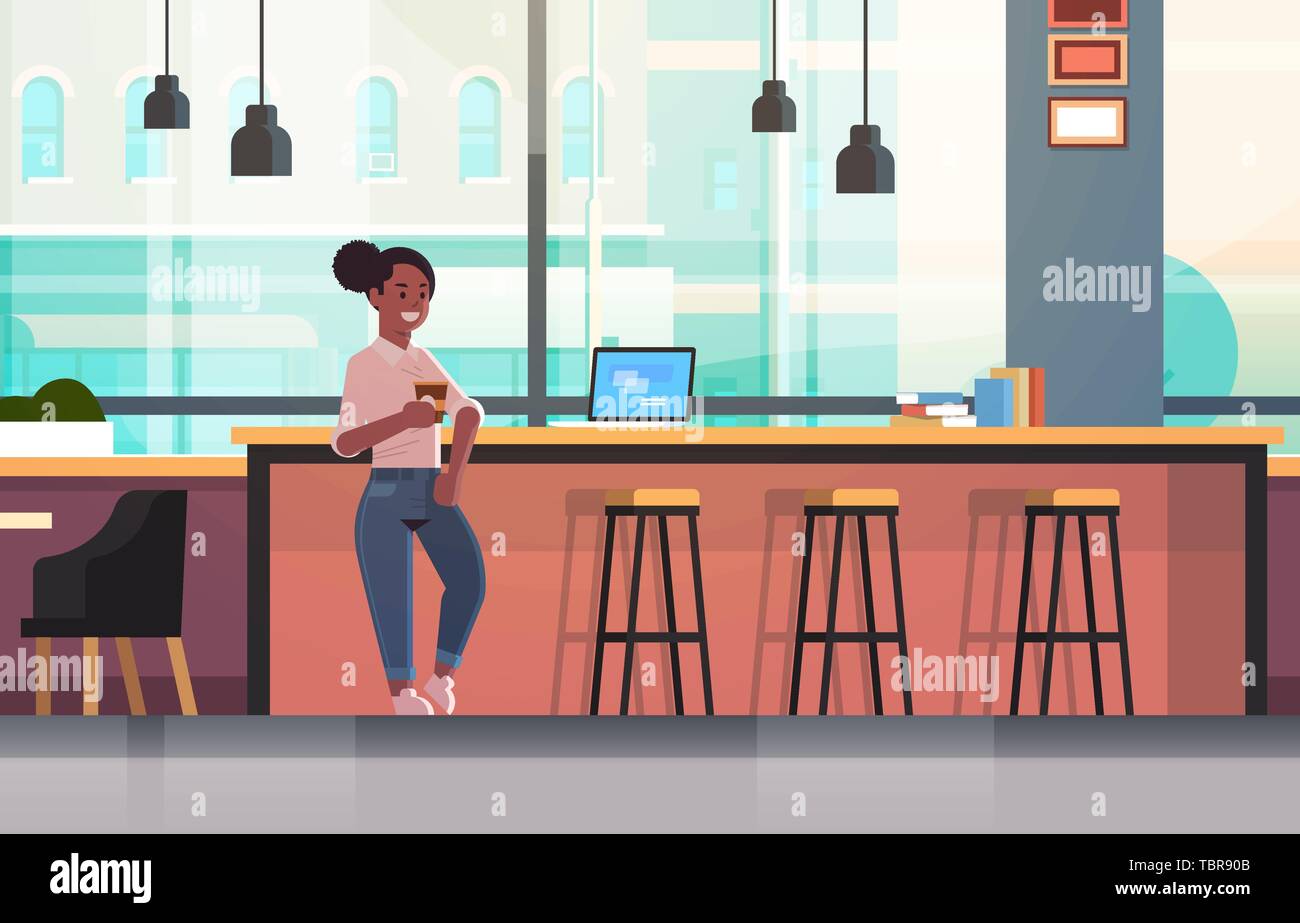Businesswoman Sitting On Chair At Bar Counter With Laptop