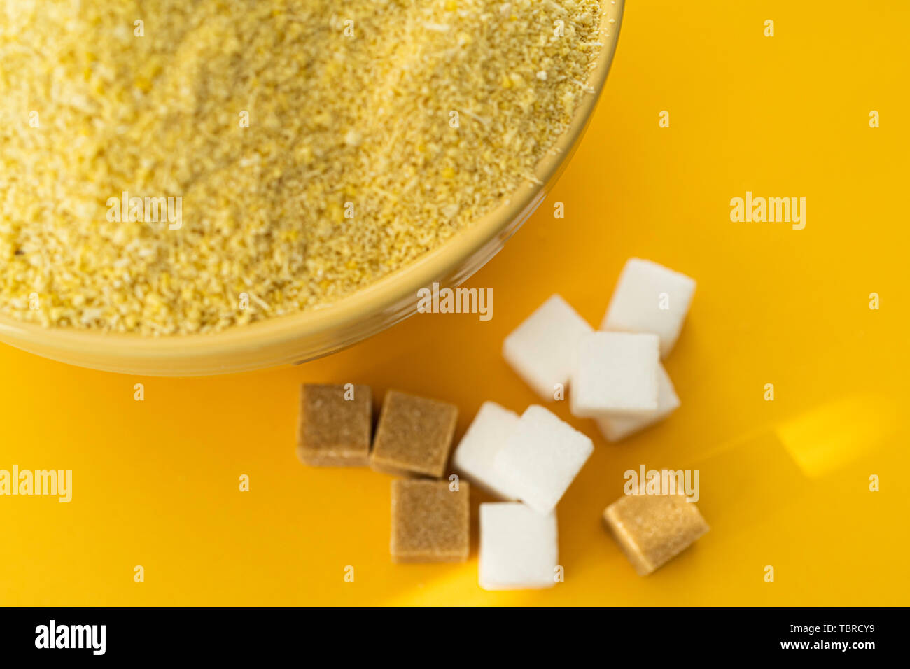 Bowl Of Nigerian Yellow Garri In Yellow Bowl With Peanuts And Sugar bowl-of-nigerian-yellow-garri-in-yellow-bowl-with-peanuts-and-sugar