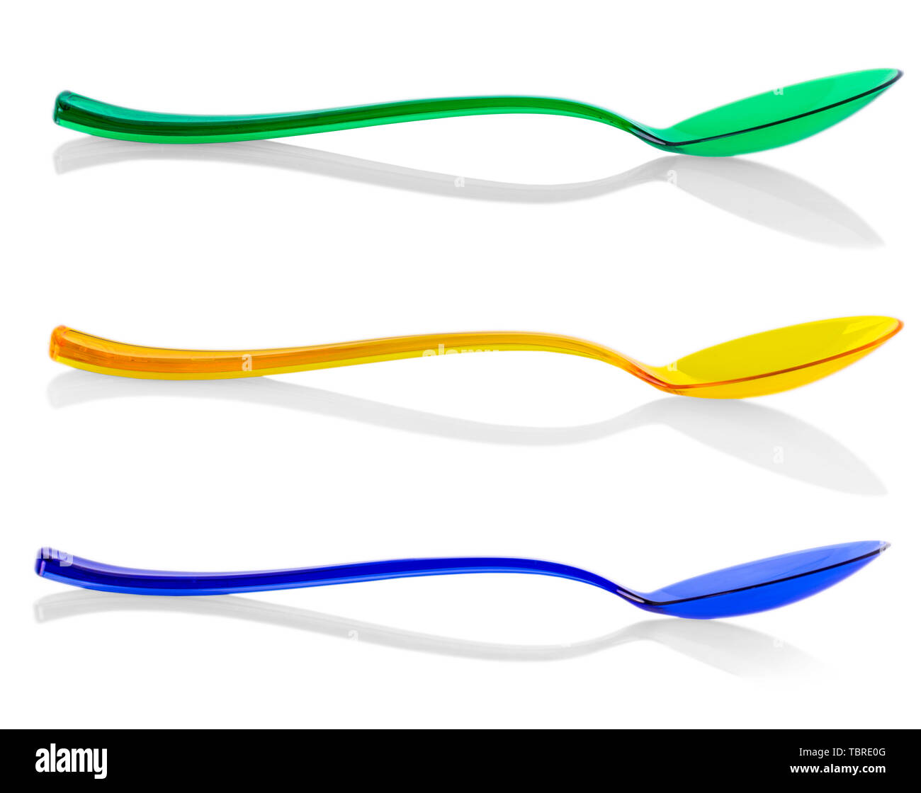 A simple bright colored plastic spoones on white background Stock Photo