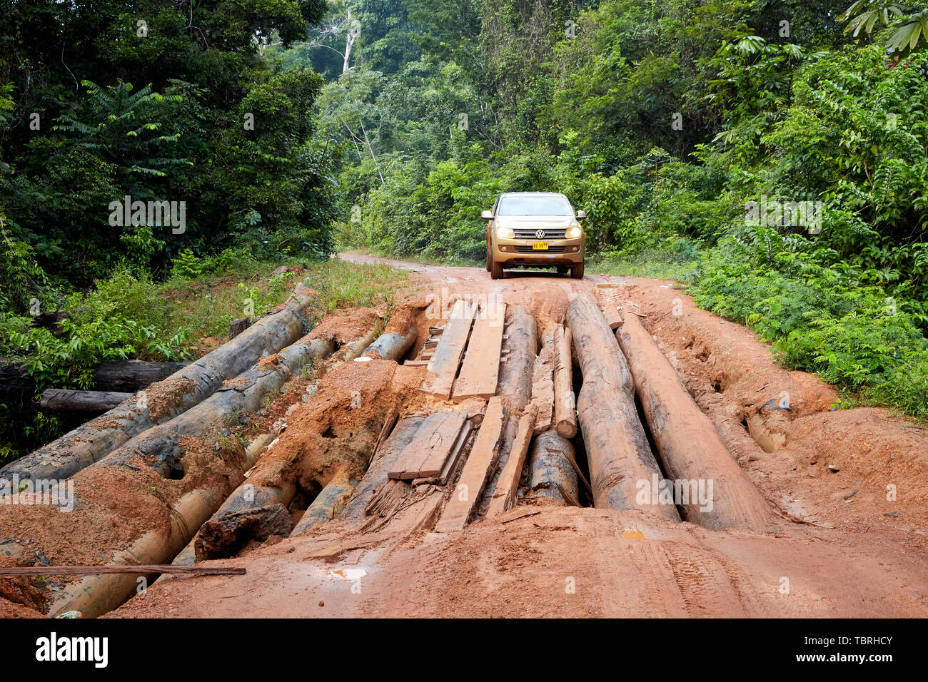 Volkswagen Amarok car pickup truck attempting to drive on Log Wooden Bridge on Linden-Lethem Road in Guyana South America Stock Photo