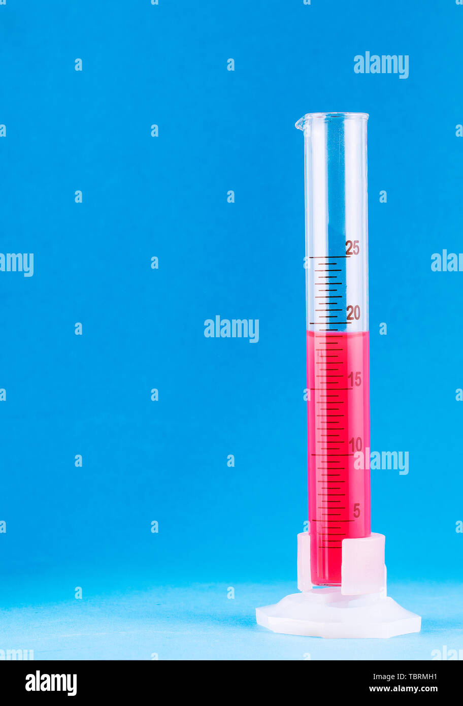 laboratory beaker with red fluid on blue background Stock Photo - Alamy