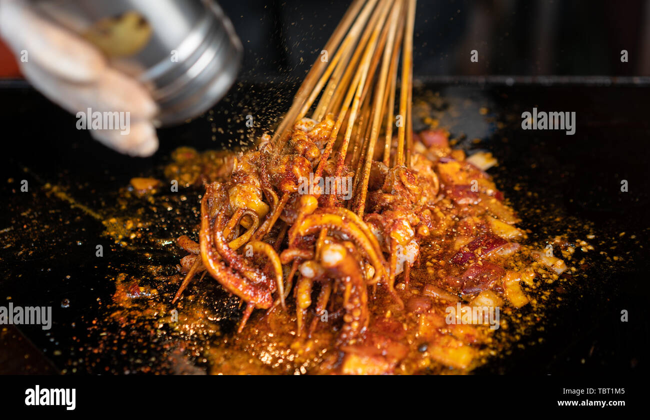 Grilled squid in the making Stock Photo