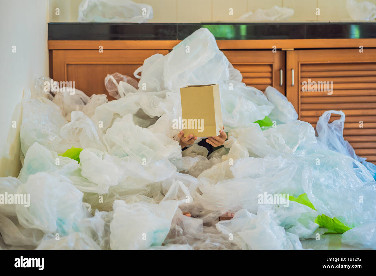 Paper bag amid a pile of plastic bags. Zero waste concept. The concept