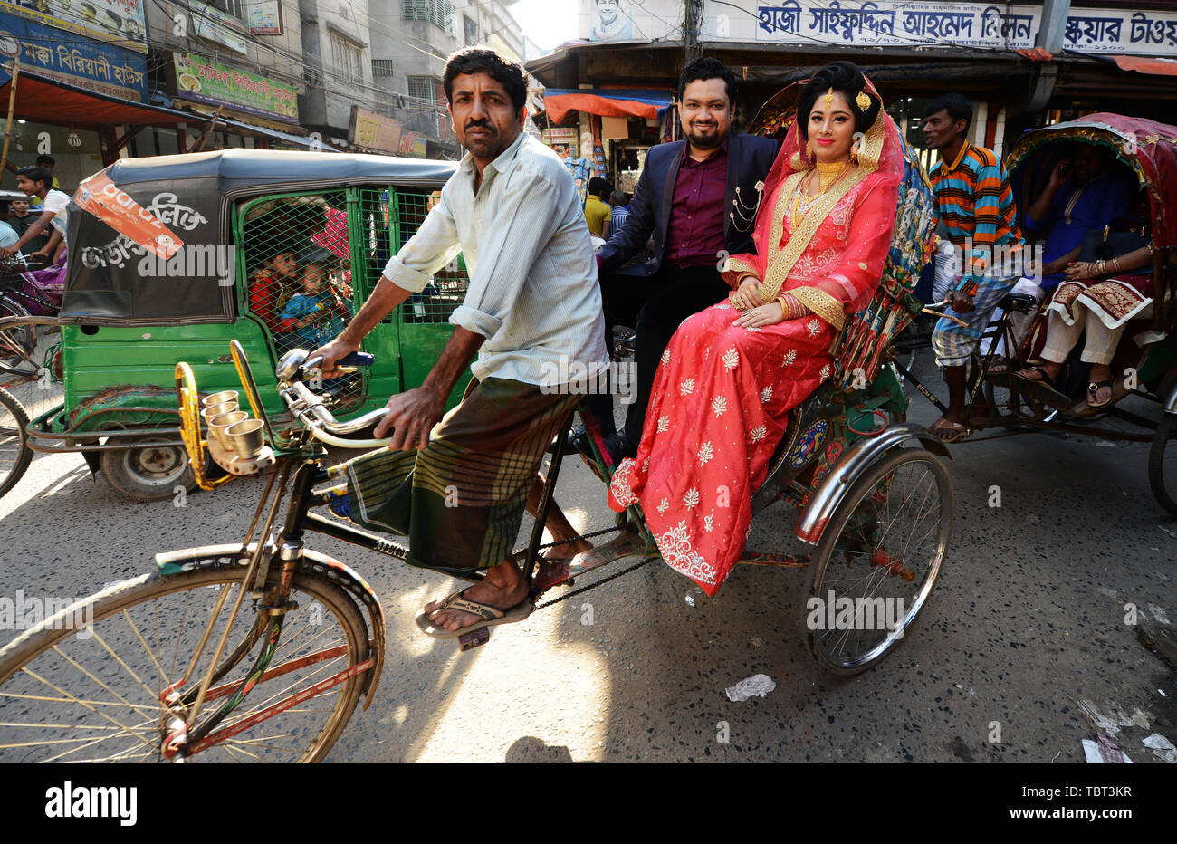 A Bangladeshi newlyweds on a cycle rickshaw in Old Dhaka. Stock Photo