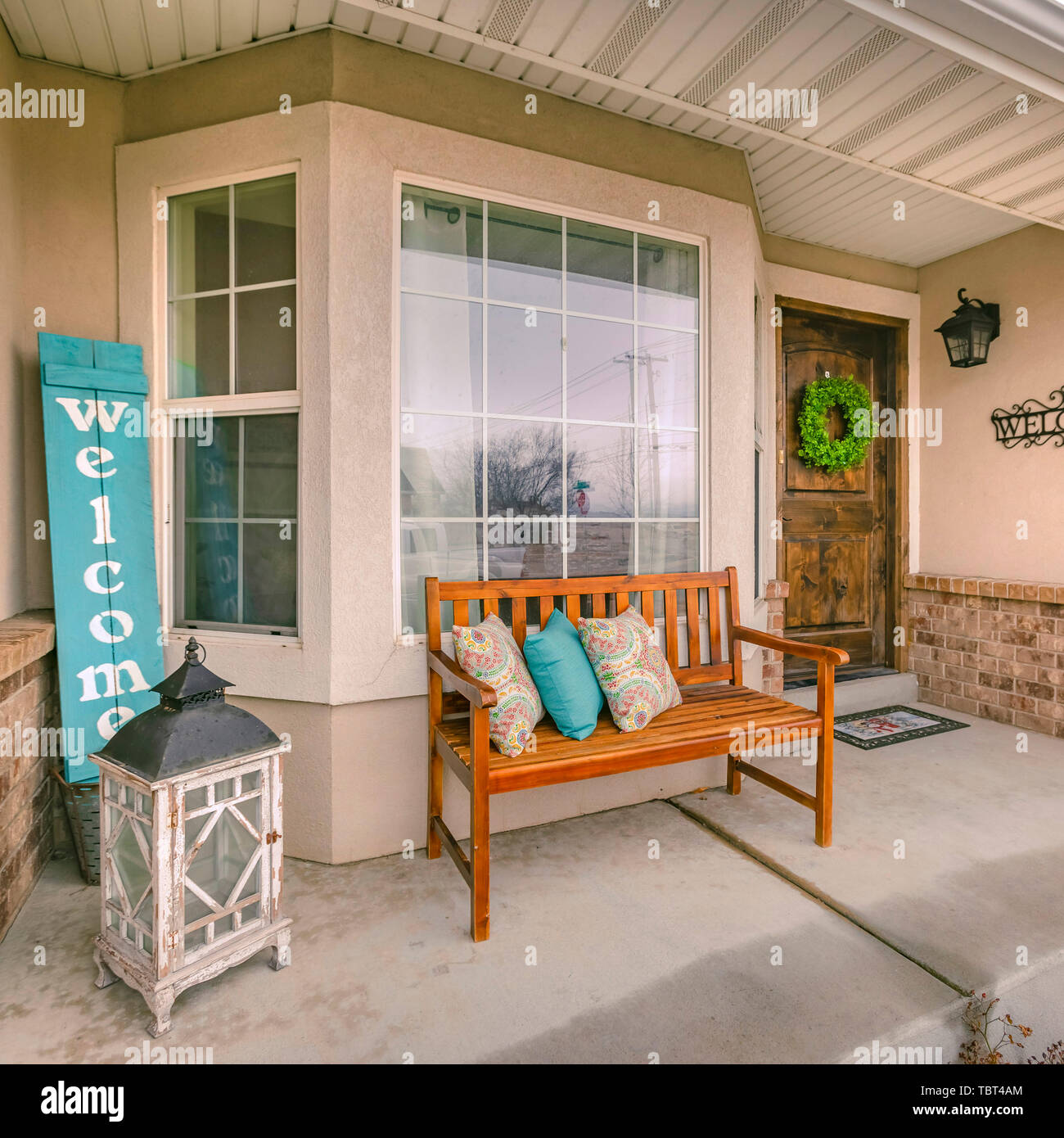 Square frame Wooden porch bench with pillows against the shiny front window Stock Photo Alamy