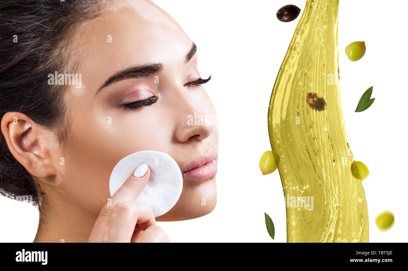 Circulate splash of olive oil near female feet. Skincare concept. Stock Photo