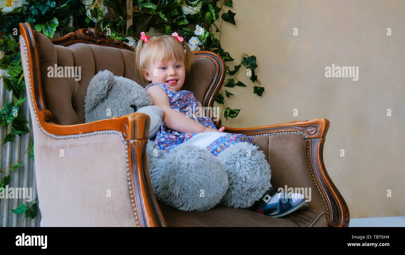 Portrait of funny little girl with bear doll at home Stock Photo