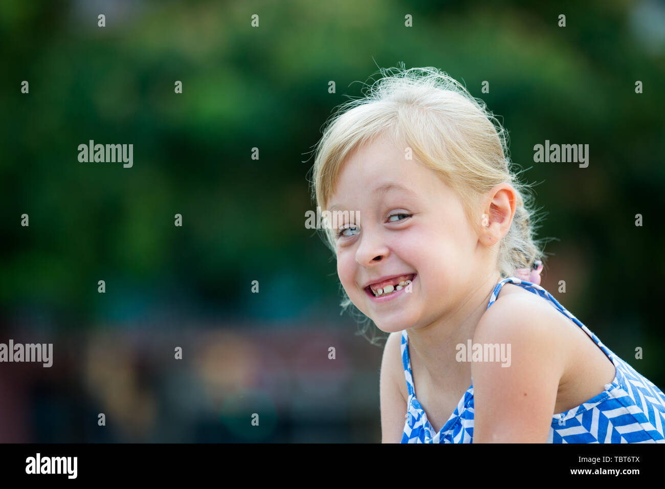 Portrait of cute smiling little girl in summer park Stock Photo - Alamy