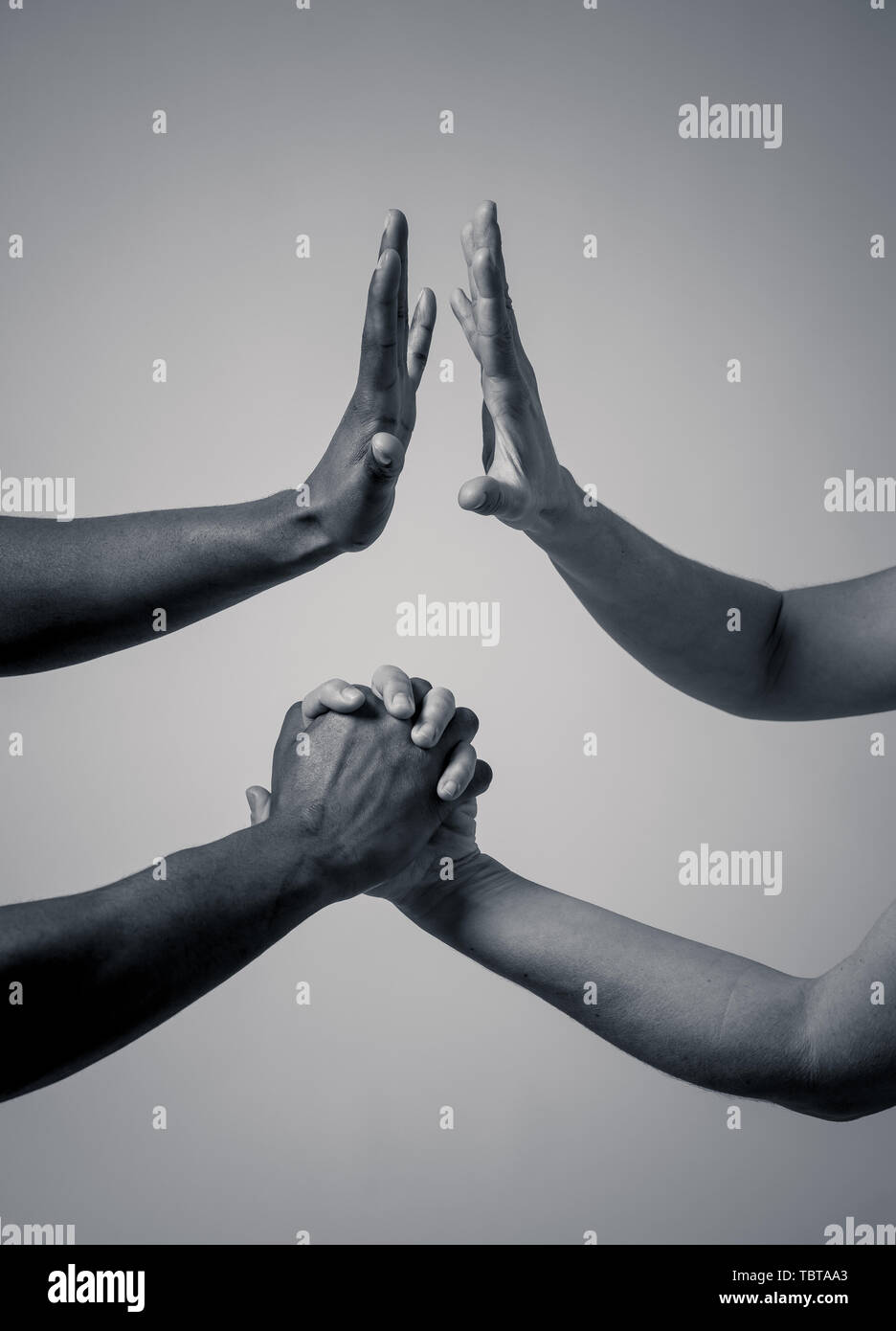 Black African American and Caucasian hands holding together. Conceptual image of Races coming together in world unity and stop racism. In racial toler Stock Photo