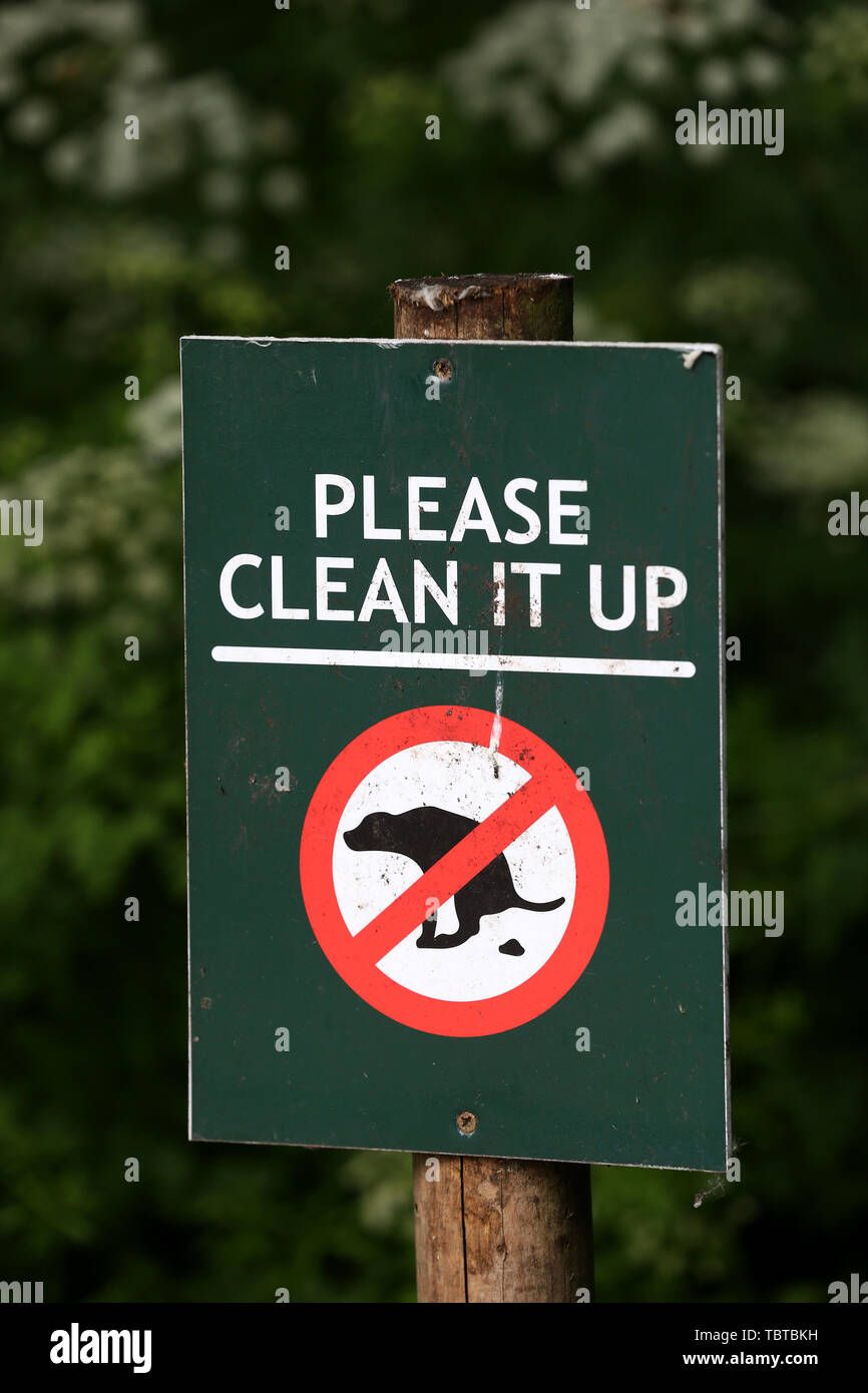A Please clean it up sign asking dog owners to clean up after their pets, London, UK. Stock Photo