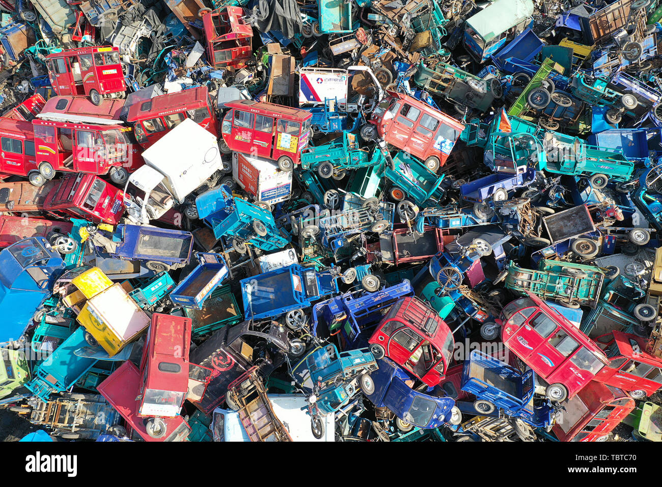 Piled together, scrap-out old motor vehicles waiting to be dismantled. Stock Photo