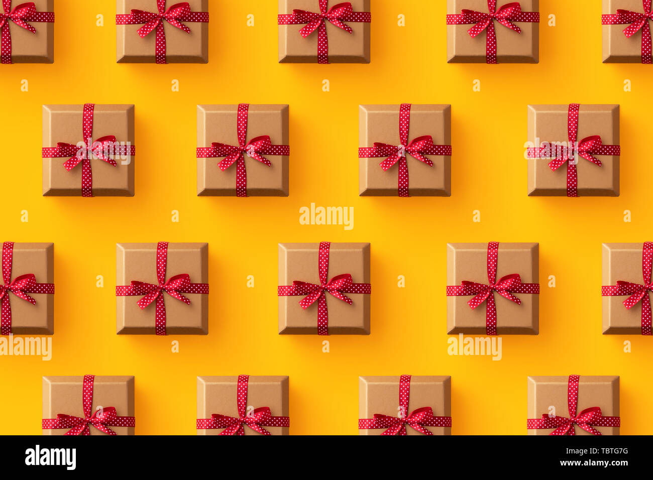 Multiple gift boxes organized over yellow background, top view Stock Photo