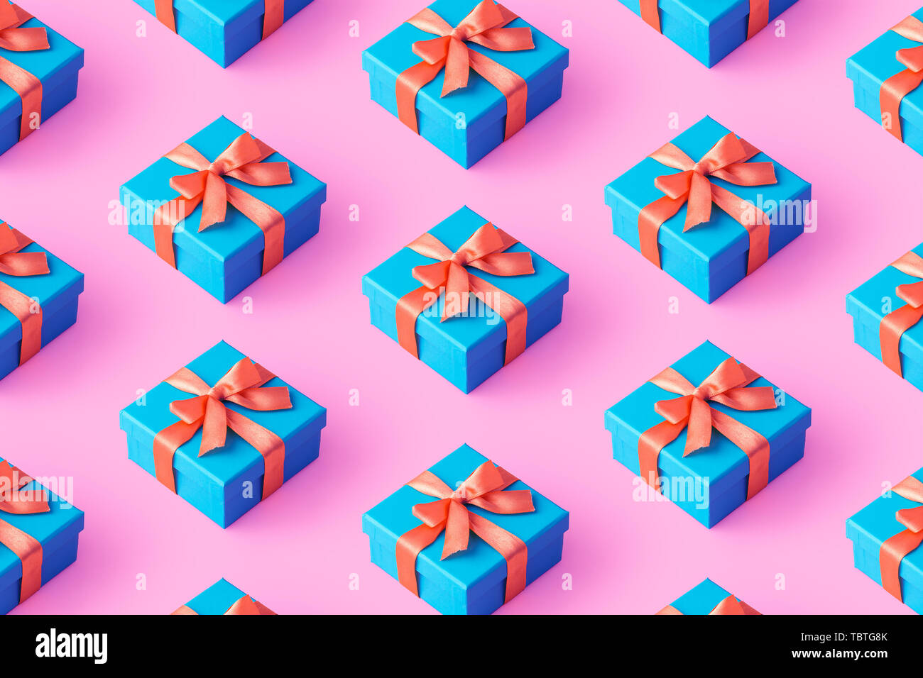 Multiple blue gift boxes organized over pink background, top view Stock Photo
