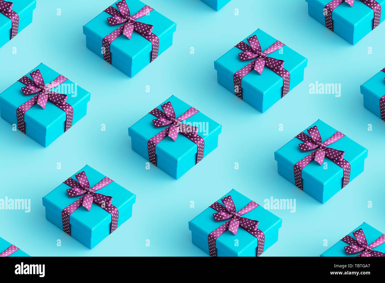 Multiple blue gift boxes organized over blue background, top view Stock Photo