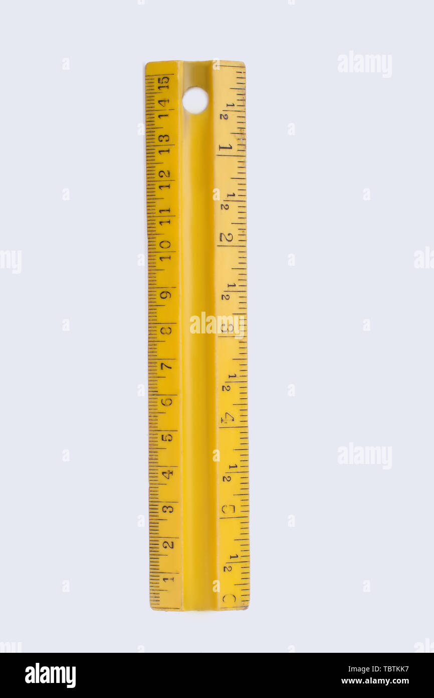 Yellow plastic ruler isolated on white background. Measuring instrument