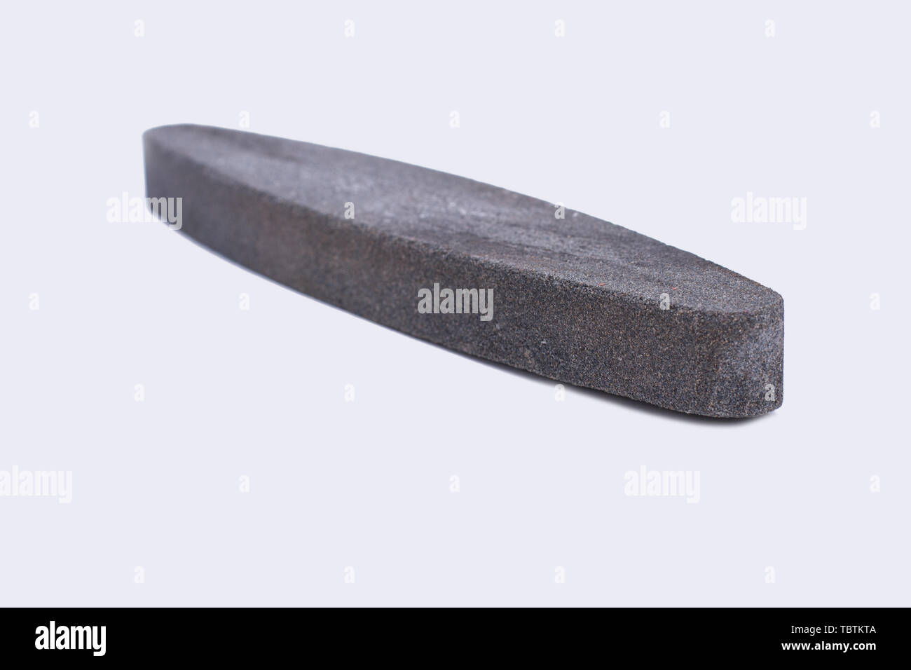Whestone sharpener isolated on white background. Gray sharpening stone. Stock Photo