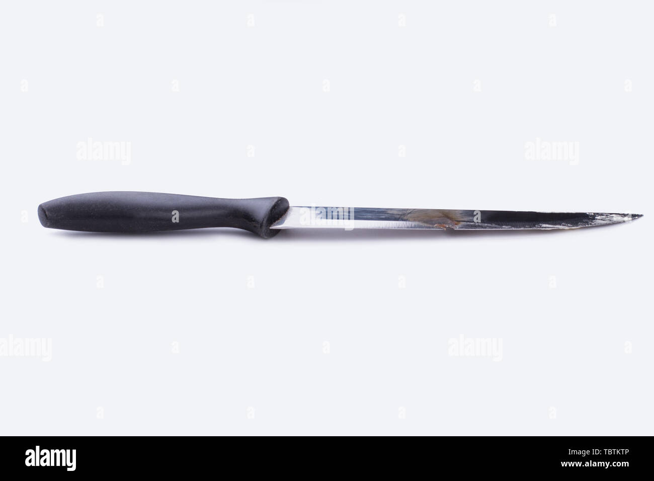 Rusty old knife with black rubber handle. Used knife isolated on white background. Space for text. Stock Photo