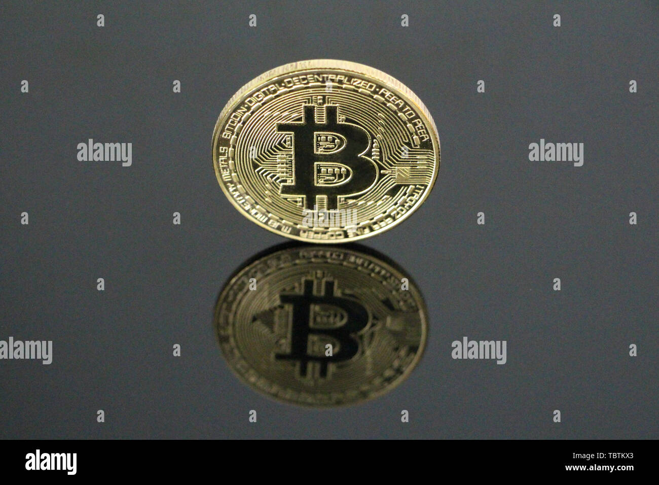 One gold coin bitcoin on a black background. Bitcoin is on its side. One  can see his reflection. Cryptocurrency concept gold bitcoin. No people,  empty Stock Photo - Alamy