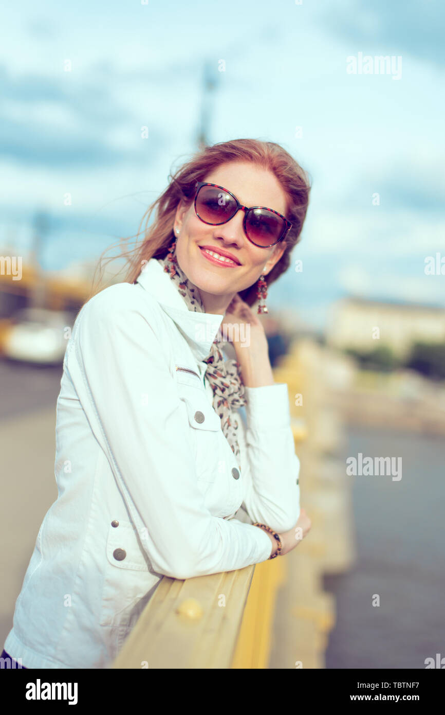 Stylish young woman with new life portrait on bridge, vintage style Stock Photo