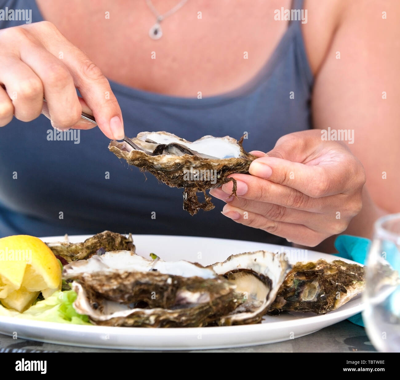 woman eat with a fork oysters Stock Photo Alamy
