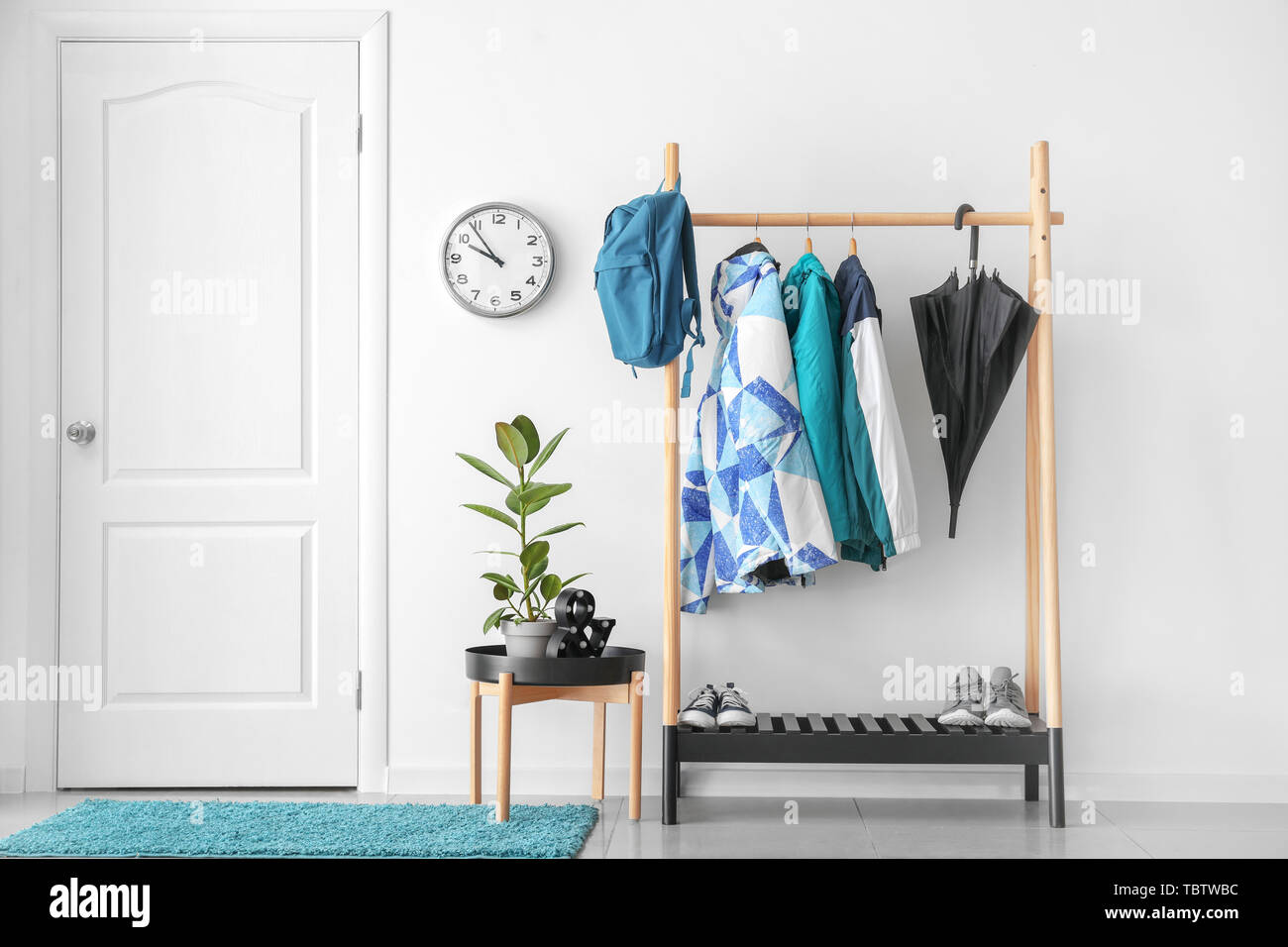 Rack with clothes in stylish interior of hall Stock Photo - Alamy