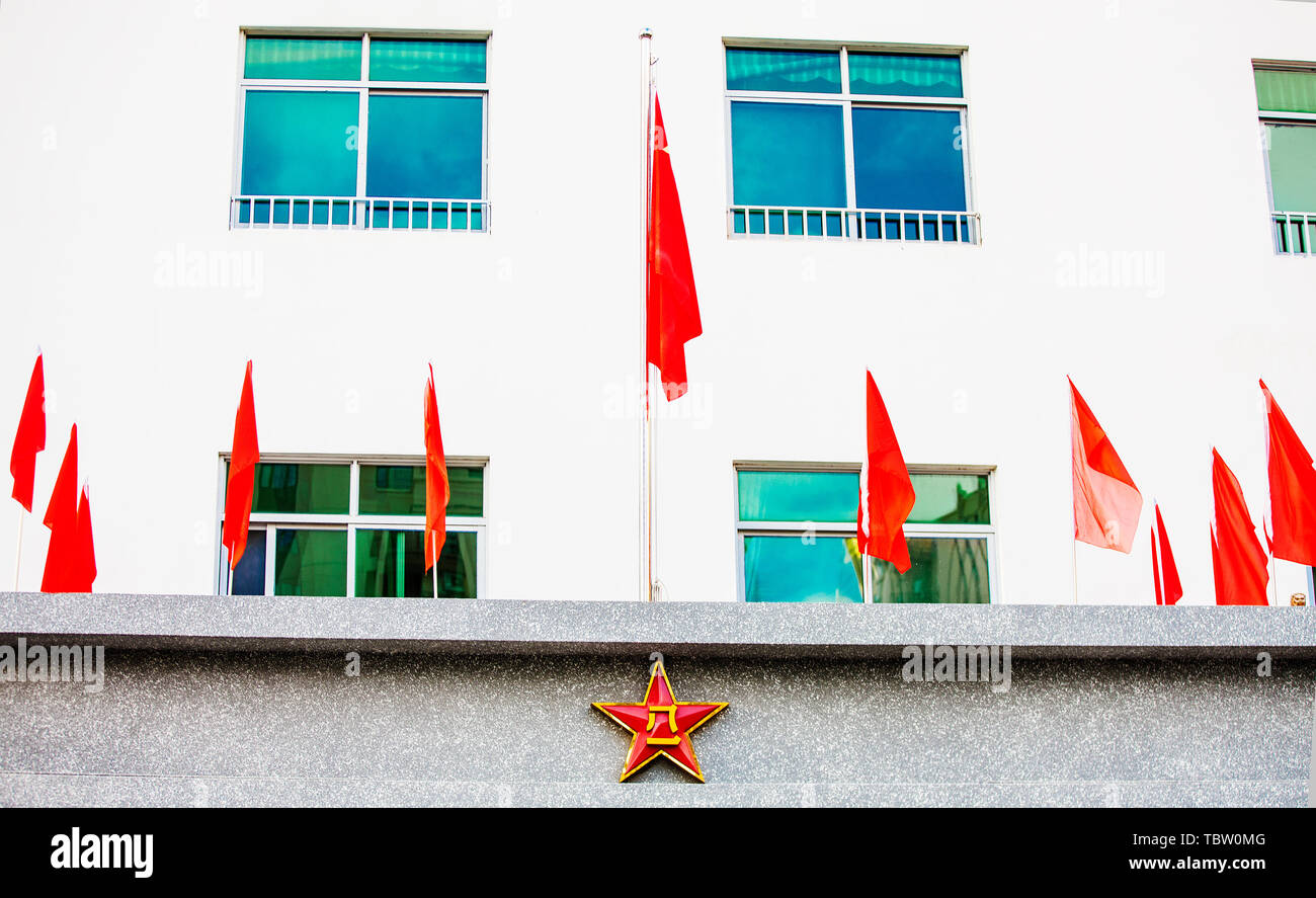 Chinese national emblem and flag on the building Stock Photo - Alamy
