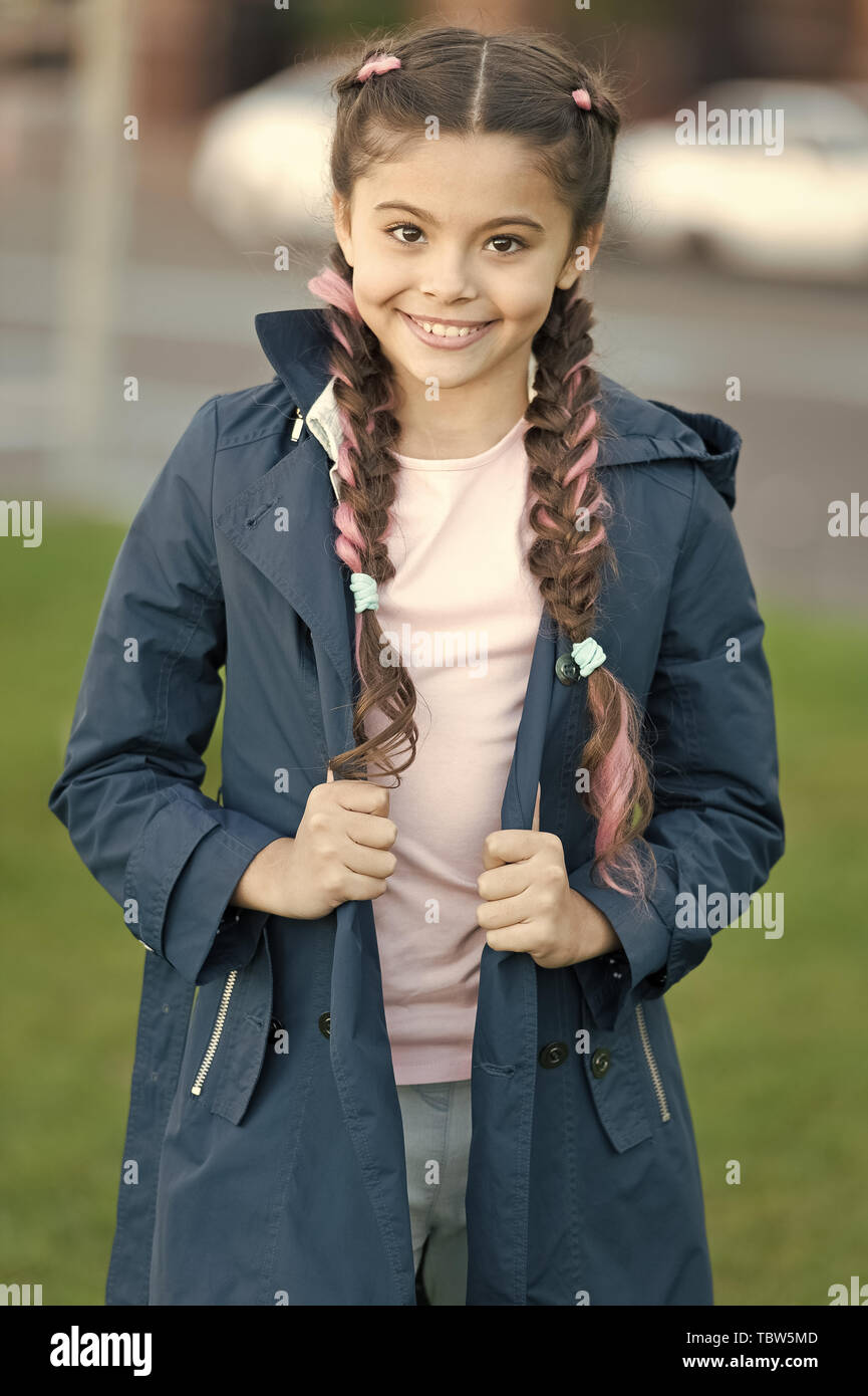 Girl with braided hair style with pink kanekalon. Add bright detail. Little girl with cute braids wear dark coat nature background. Kanekalon strand in braids of cute child. Modern hairstyle concept Stock Girl with braided hair style with pink kanekalon. Add bright detail. Little girl with cute braids wear dark coat nature background. Kanekalon strand in braids of cute child. Modern hairstyle concept Stock
