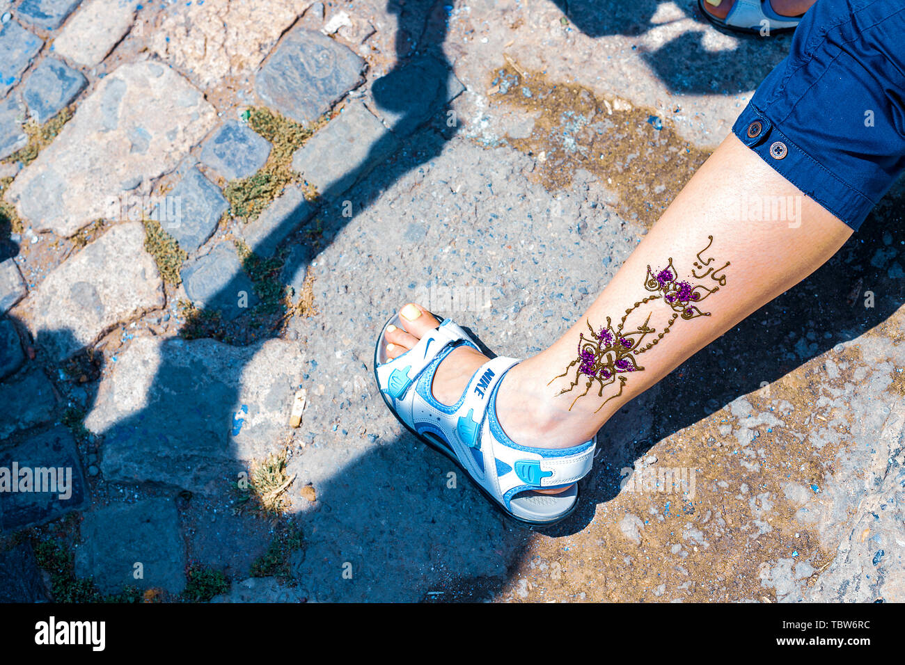 Artist applying henna tattoo on women in the streets of Marrakech
