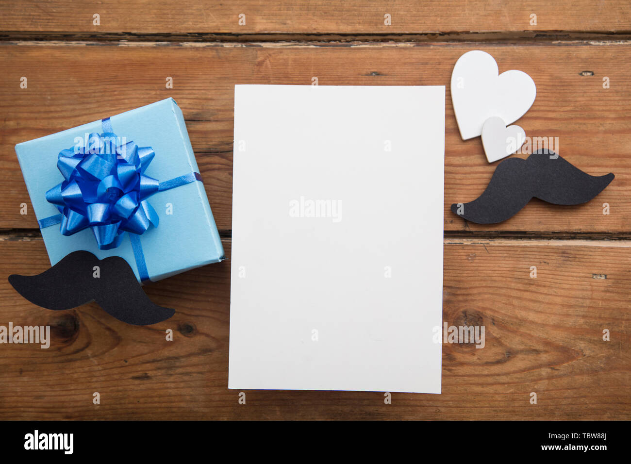 Happy Father's Day blank card composition with gift box and mustache Stock Photo