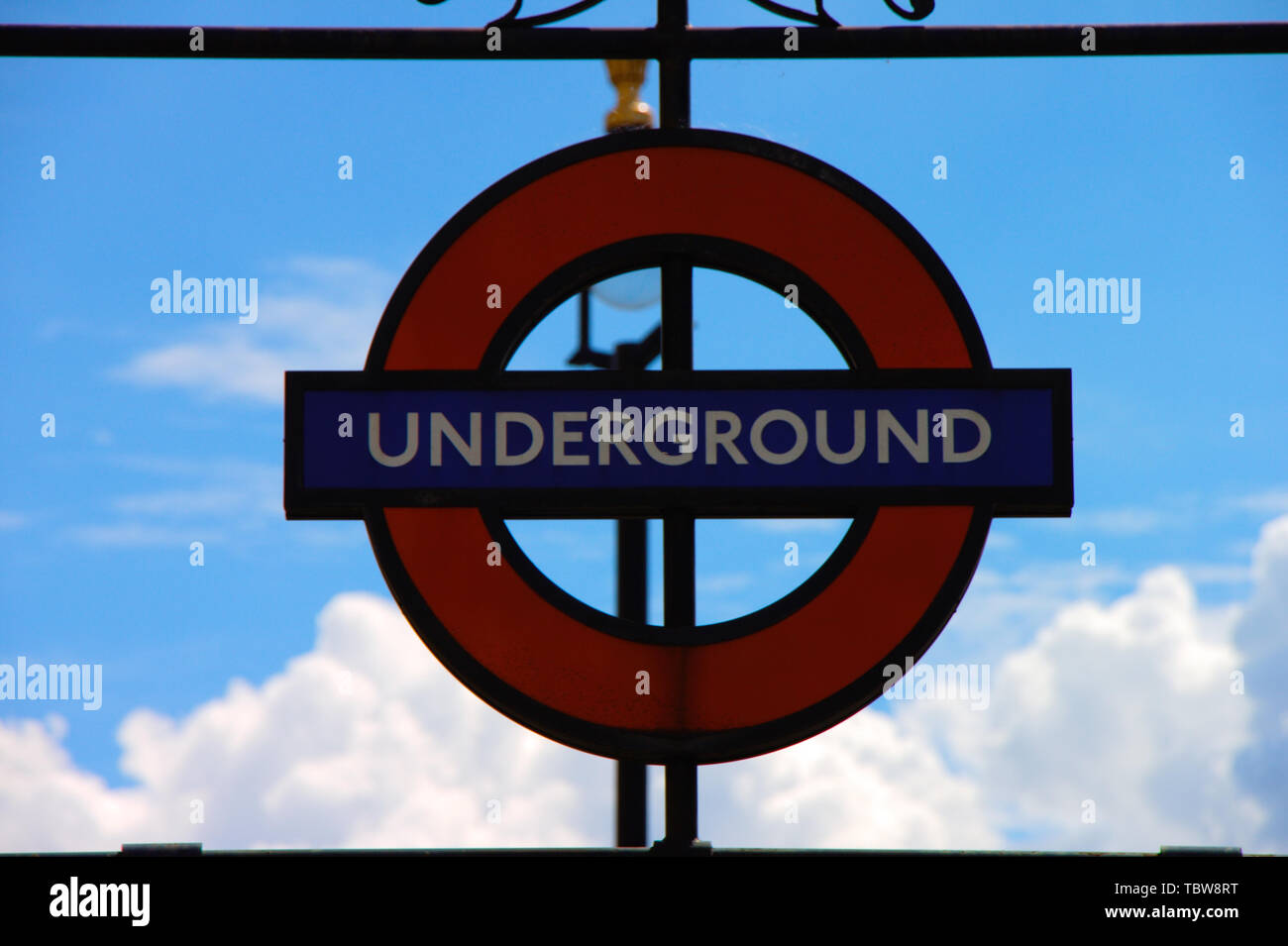 Westminster station underground sign in front of sky. London. Stock Photo