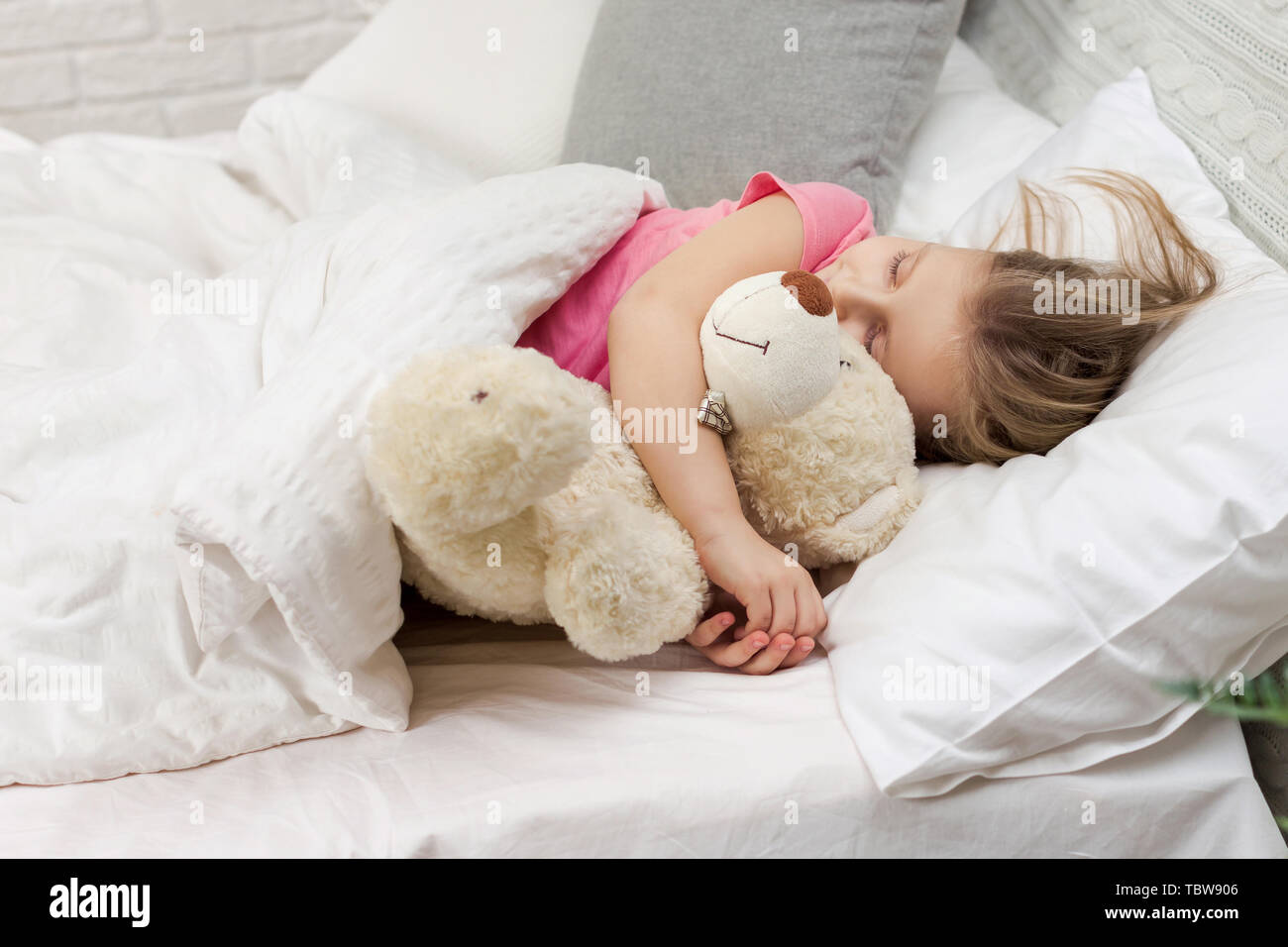 Cute little child girl sleeping with teddy bear in her bed Stock Photo ...