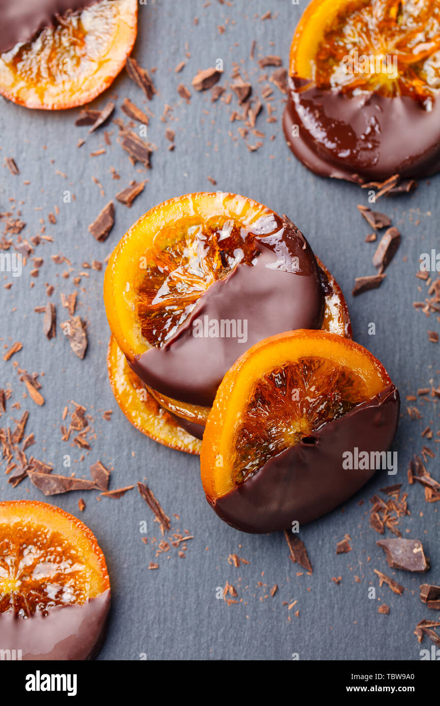 Candied orange slices in chocolate. Slate background. Top view Stock