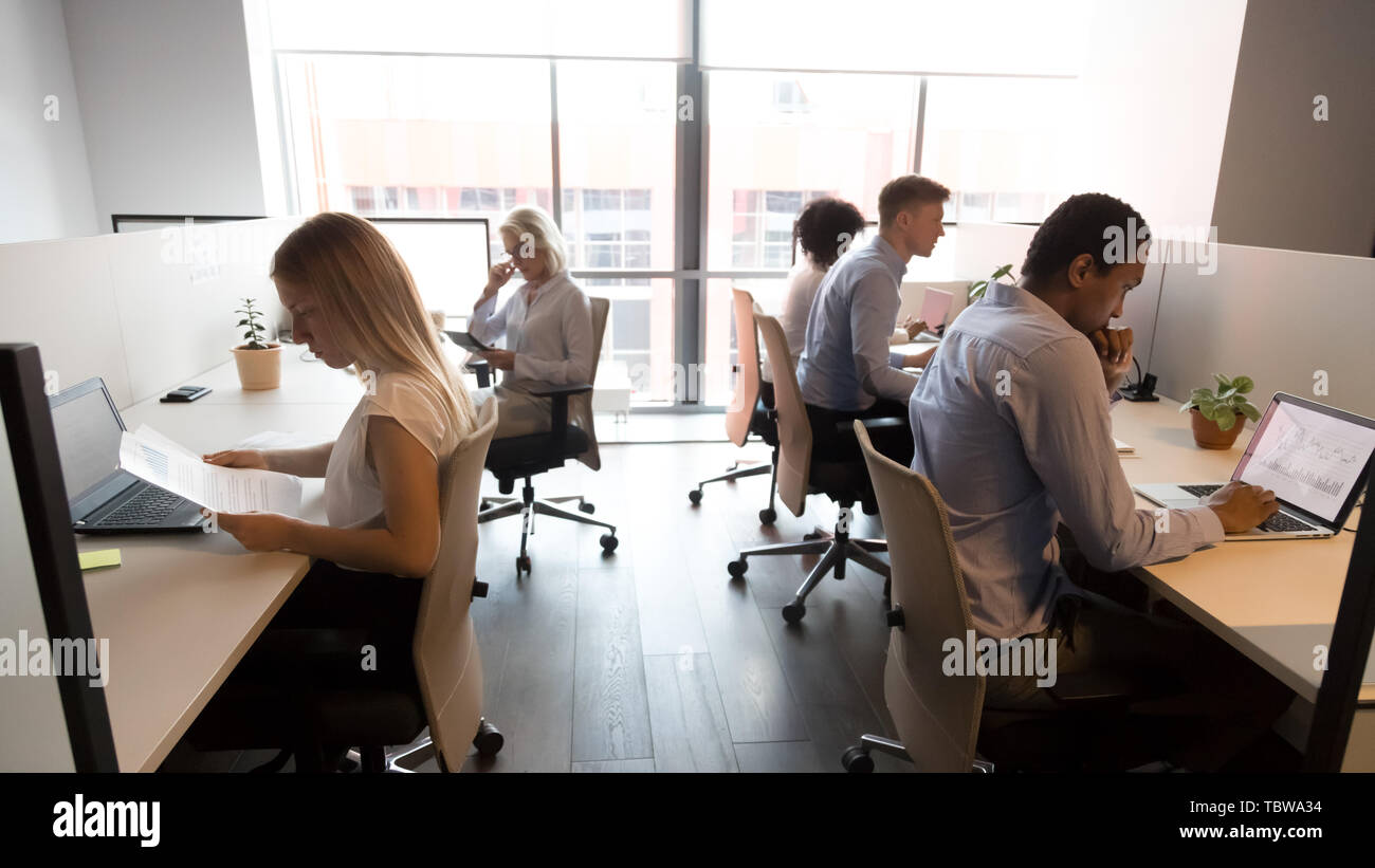 Diverse business people working in office, using computers, workday Stock Photo