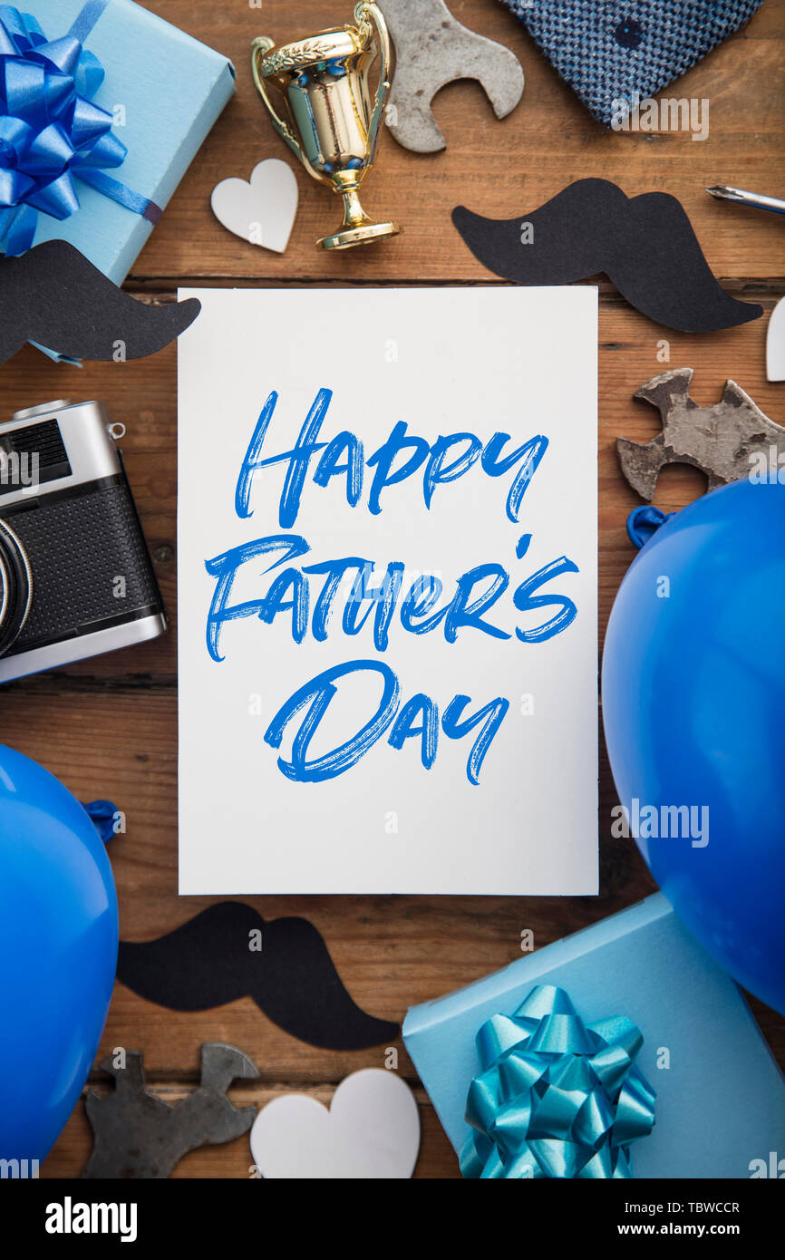 Happy Father's day card composition with gifts, mustache, trophy, camera Stock Photo