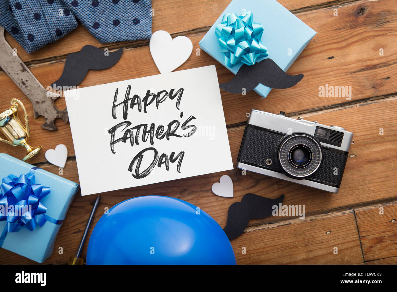Happy Father's day card composition with gifts, mustache, trophy, camera Stock Photo