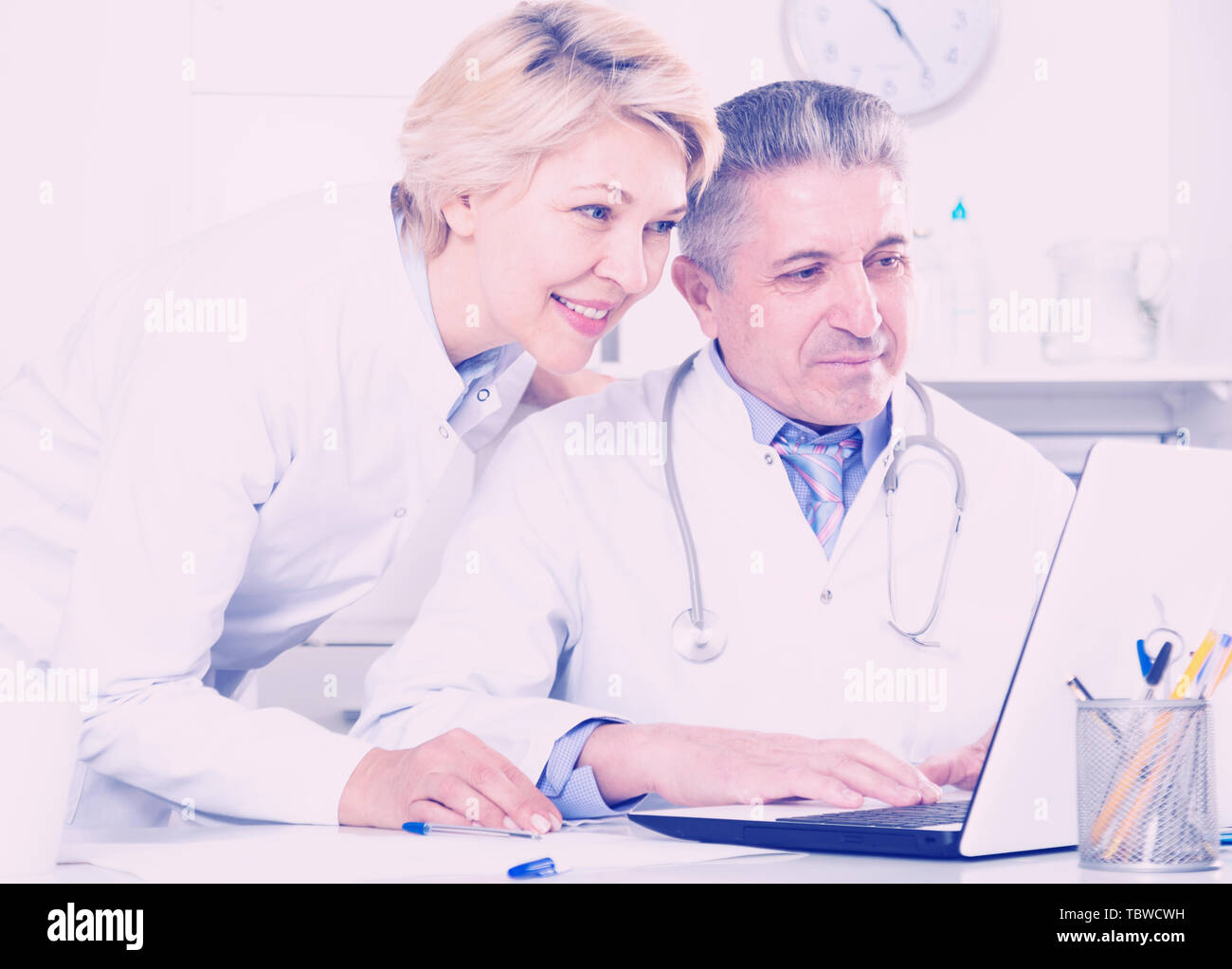 Doctor and nurse reading patient information in hospital computer ...