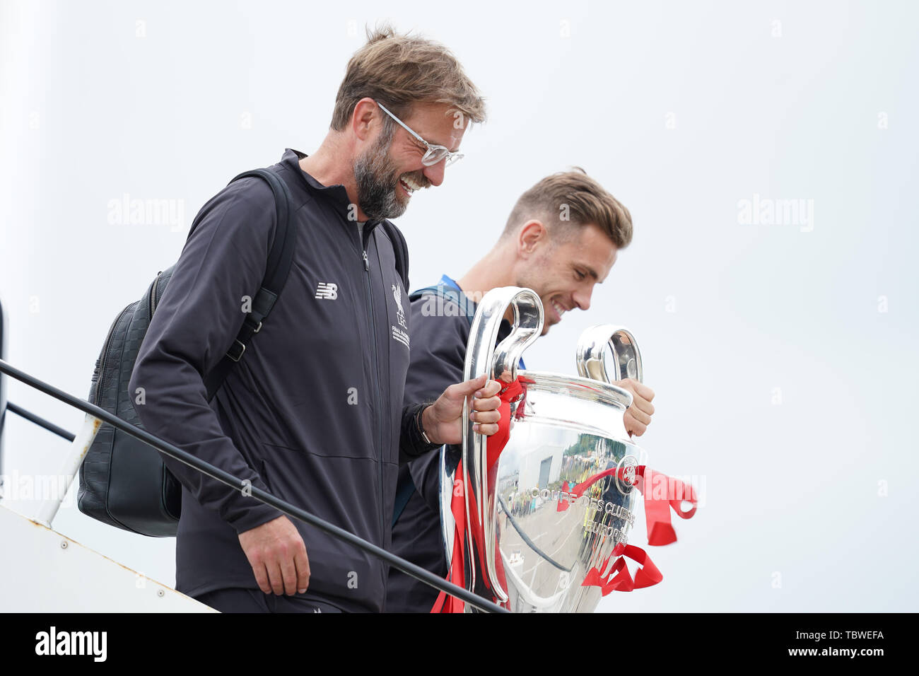 Liverpool manager Jurgen Klopp and Jordan Henderson leave the airplane carrying the European Cup   2nd June 2019 , Liverpool, England; UEFA Champions League, Liverpool FC Champions League winners celebrations and open top bus parade ;    Credit: Terry Donnelly/News Images Stock Photo