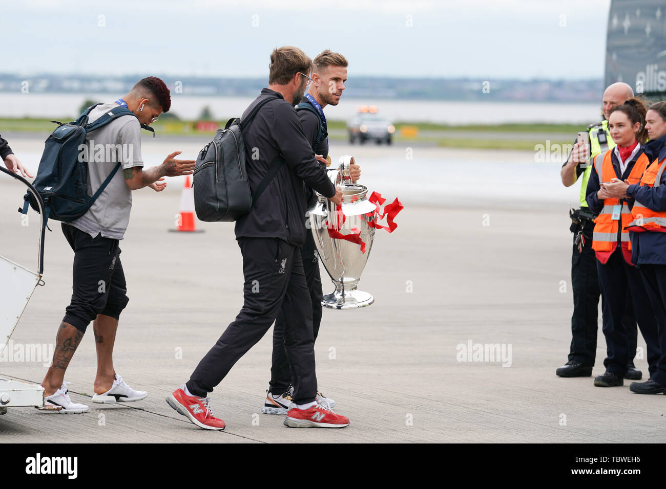 Liverpool manager Jurgen Klopp and Jordan Henderson leave the airplane carrying the European Cup   2nd June 2019 , Liverpool, England; UEFA Champions League, Liverpool FC Champions League winners celebrations and open top bus parade ;    Credit: Terry Donnelly/News Images Stock Photo