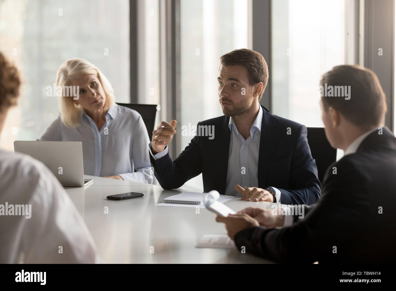 Serious colleagues brainstorm discussing project at meeting Stock Photo ...