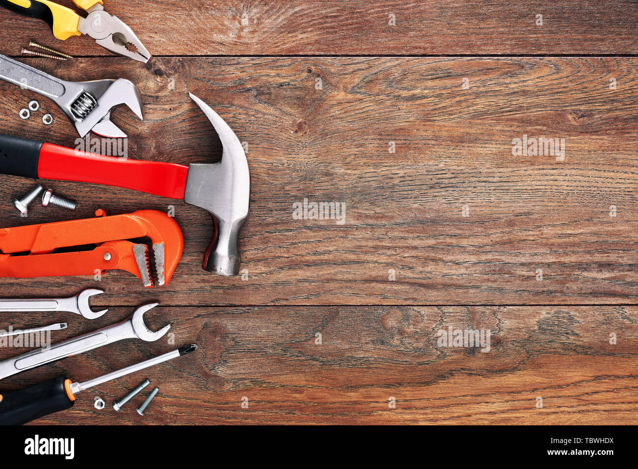 Assorted work tools on wooden background with copy space Stock Photo