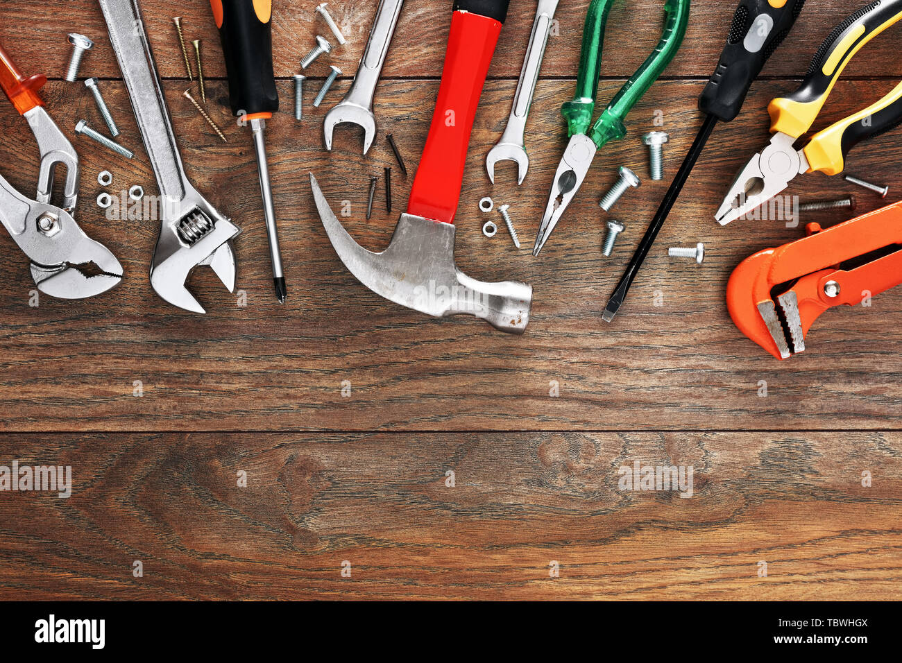 Assorted work tools on wooden background with copy space Stock Photo