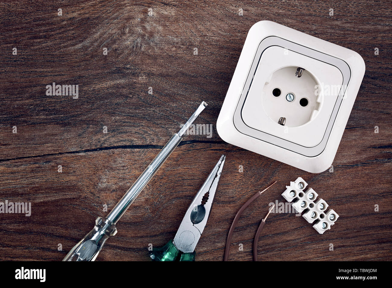 Set of electrical work tools on wooden table background with copy space. Top down close up view. Stock Photo