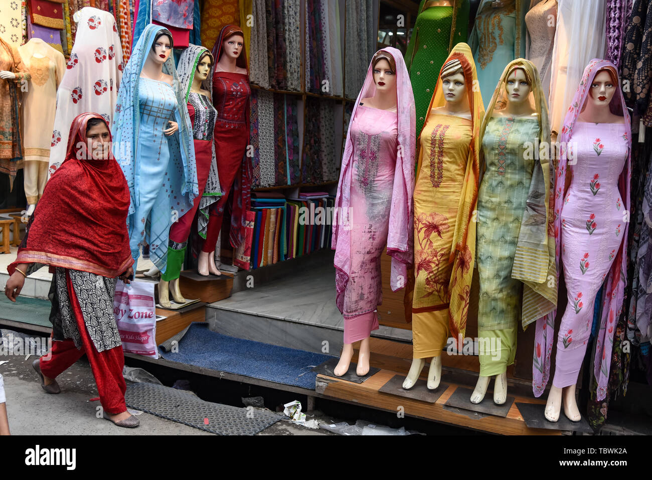Clothes seen being displayed at a shop ahead of Eid-ul-Fitr festival which marks end of the Holy fasting month of Ramadan in Srinagar. Stock Photo