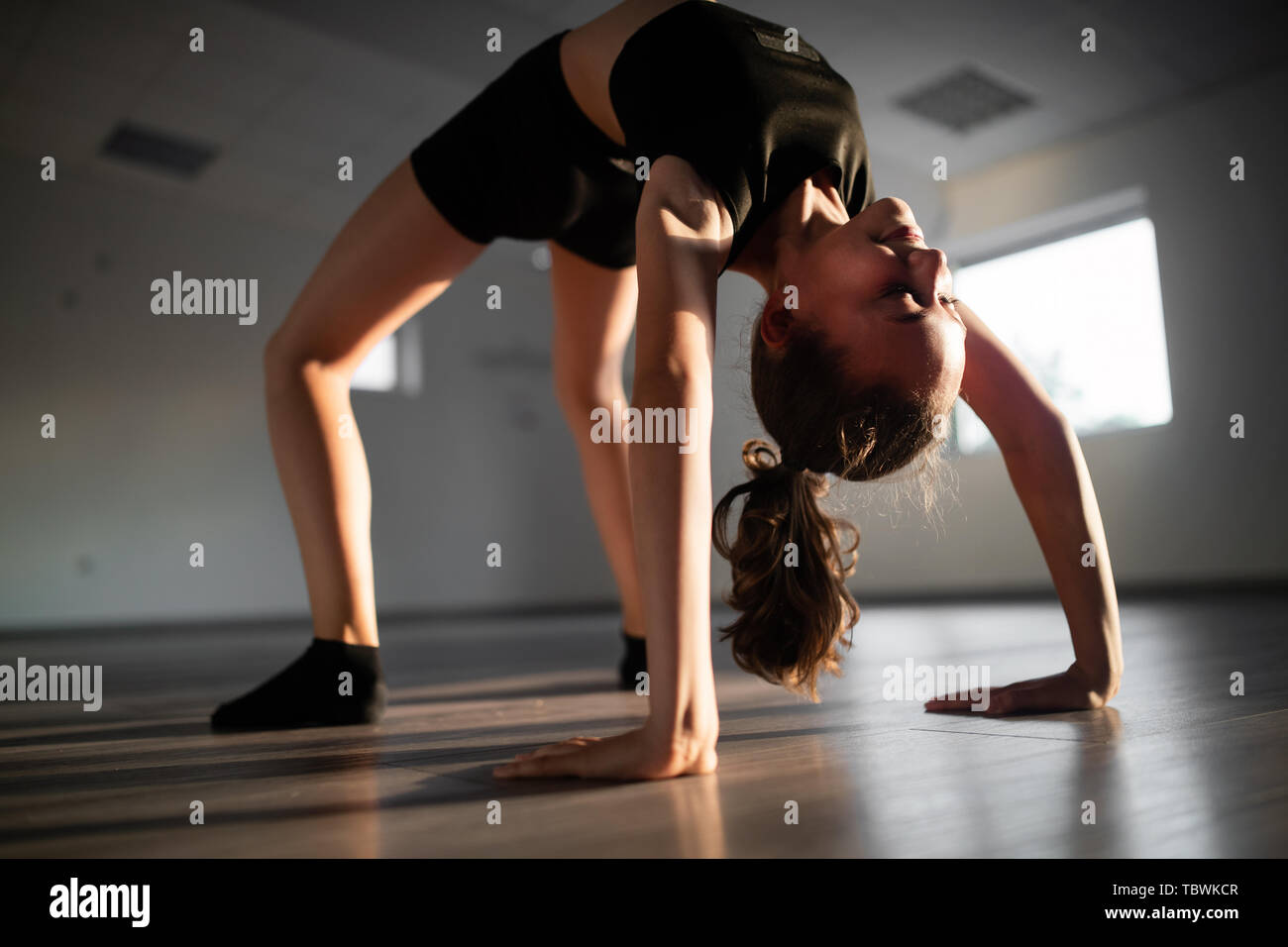 Beautiful girl practicing and exercising modern ballet at dance school Stock Photo