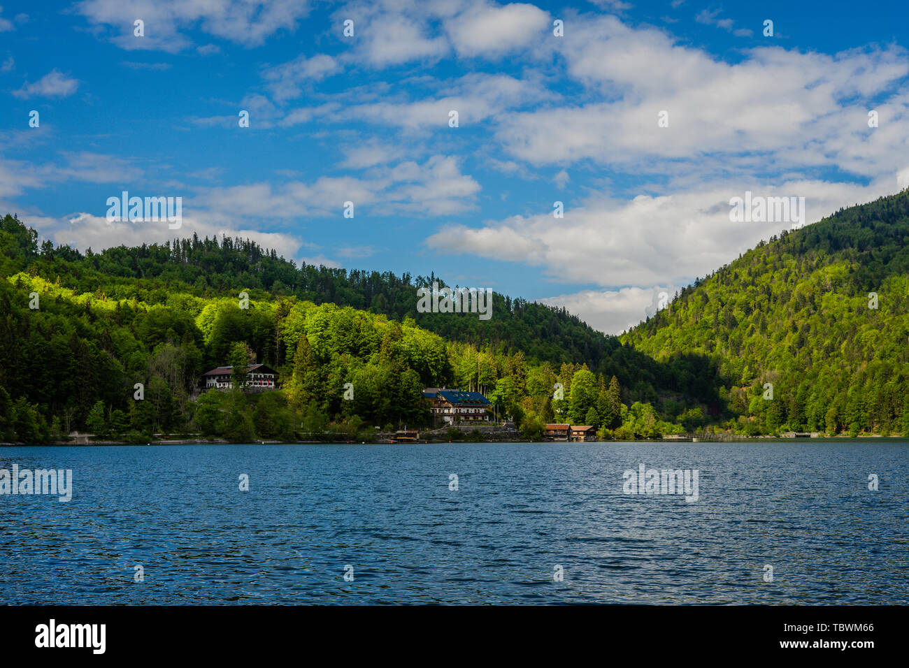 view from lakeside, lonely houses, hills and mountains Stock Photo
