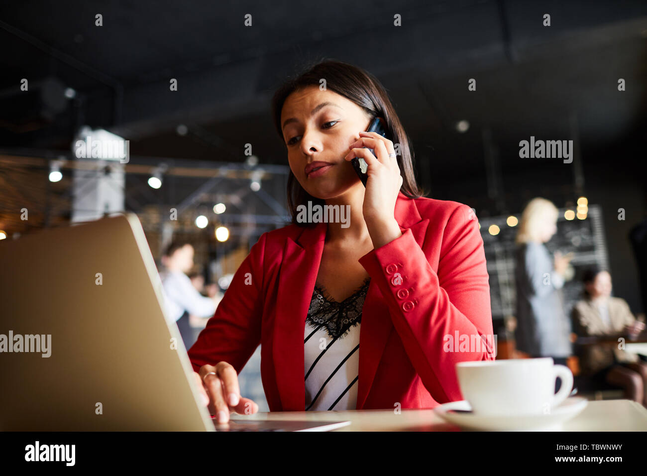Serious confident attractive young black lady manager in red jacket ...